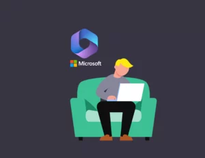 Man sitting on sofa looking at laptop with Microsoft icon in back