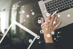 Woman typing on laptop with safety icons