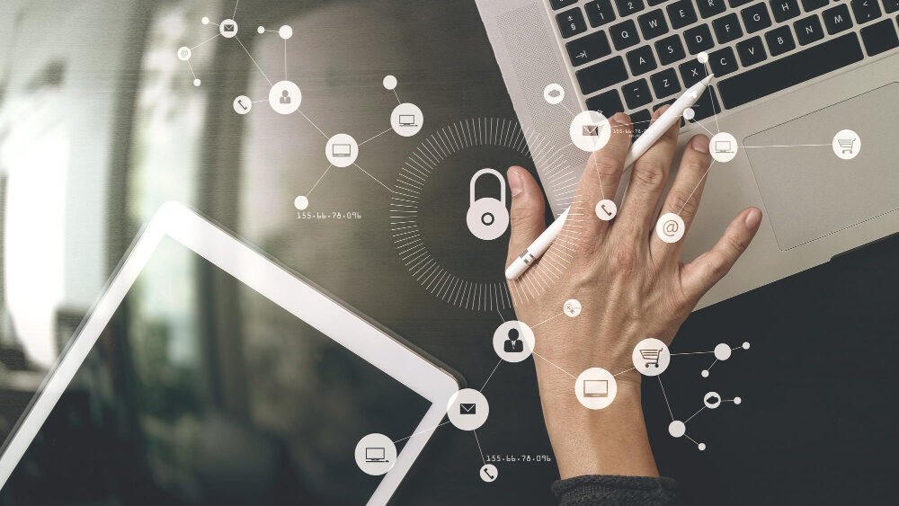 Woman typing on laptop with safety icons